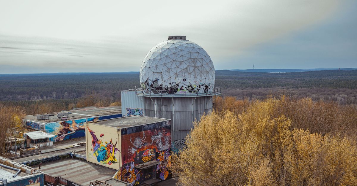 **SUBJECT:** The main subject of this photograph is an abandoned radar station, featuring a large white dome structure.