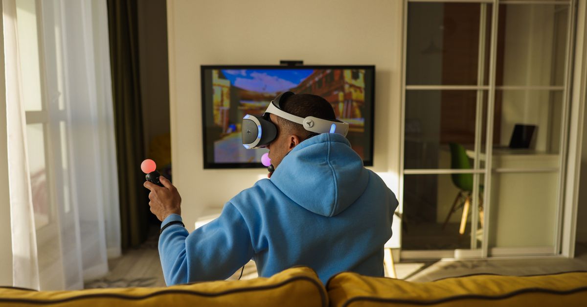 A man wearing a VR headset and holding a controller.