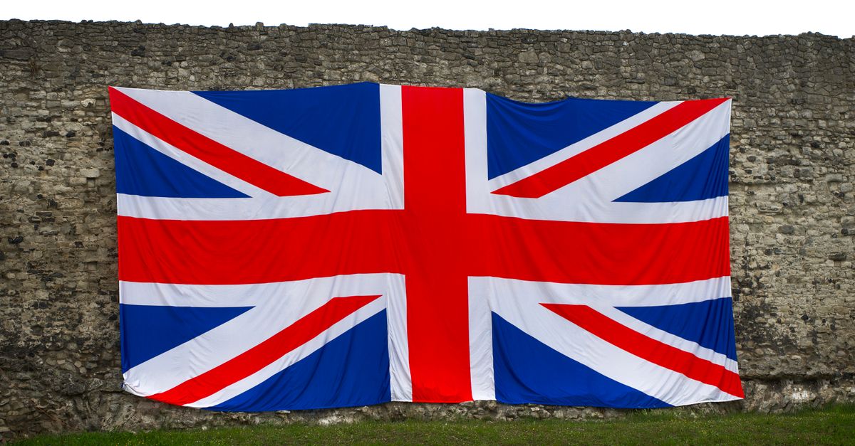 Union Jack flag draped over a historic stone wall, symbolizing British heritage in Rochester, England.