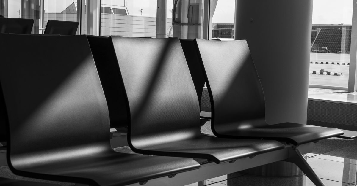 A row of empty airport terminal seating, the kind of place items get left behind.