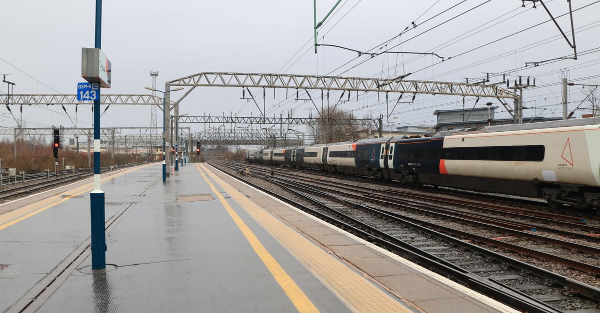A British intercity train arriving at a wet station platform