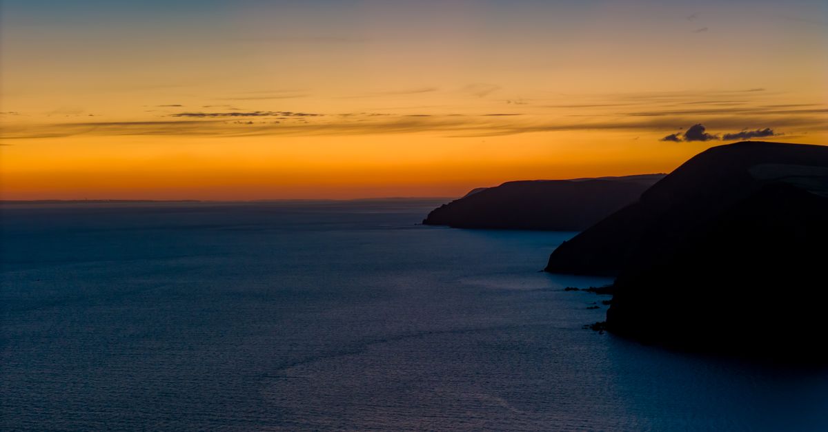 A breathtaking view of the sunrise over the Bristol Channel, capturing vivid colors and serene seascape.