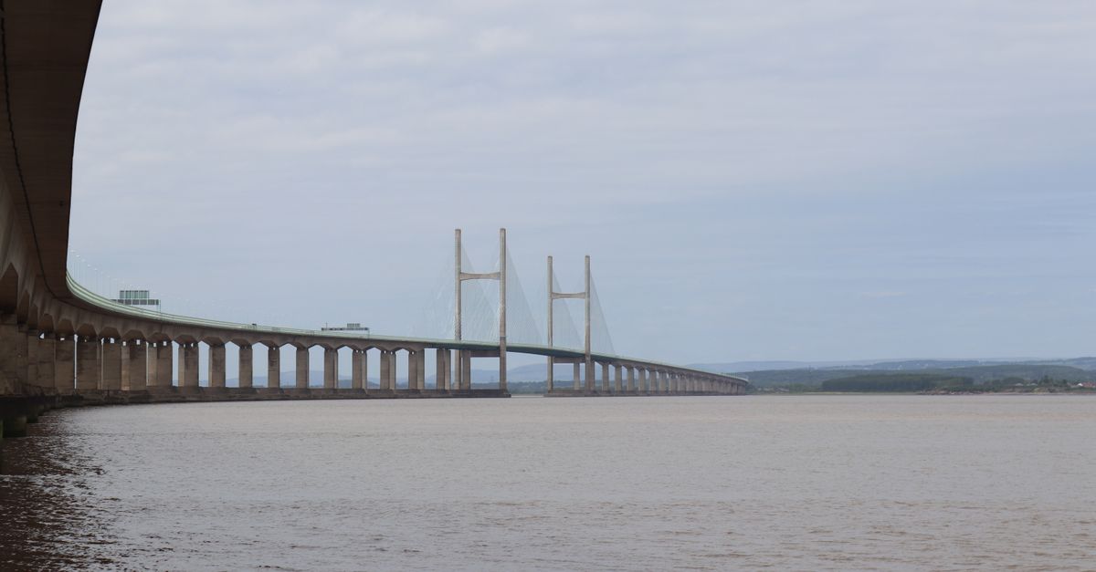 A panoramic view of the Severn Bridge over the tranquil river waters.