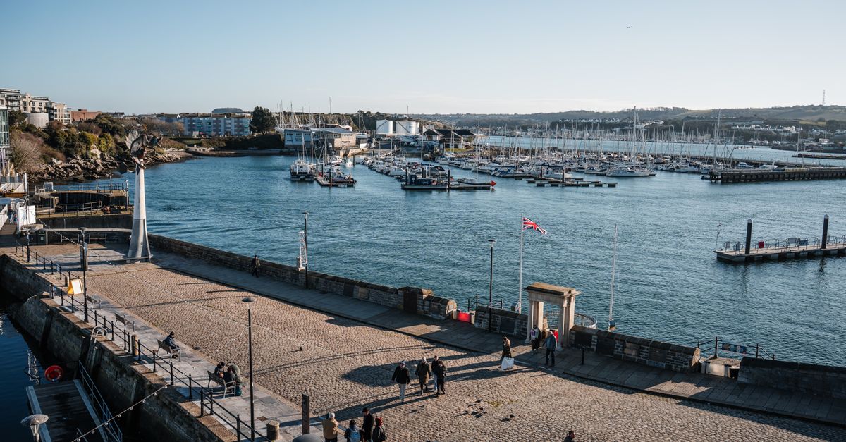 Aerial view of Plymouth Marina on a clear day with people walking on the promenade.