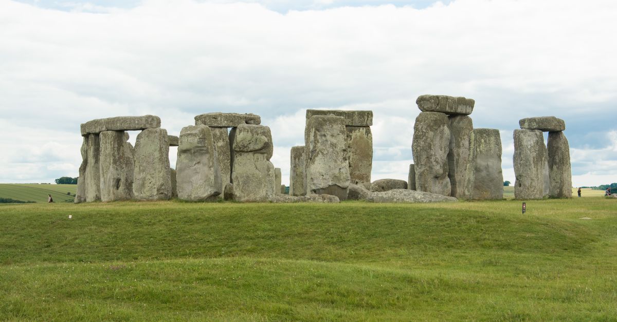 Captivating photograph of Stonehenge, a prehistoric monument in England, seen under a cloudy sky.