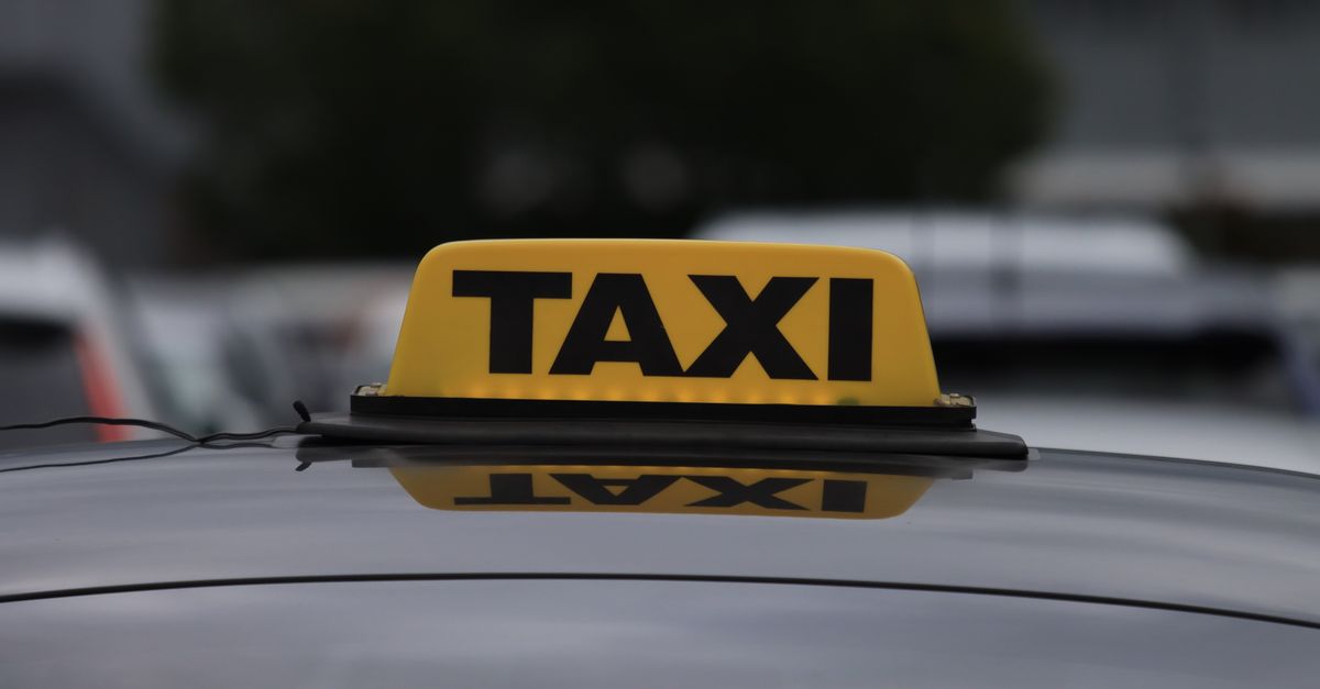 Generic yellow 'TAXI' roof sign on a car roof