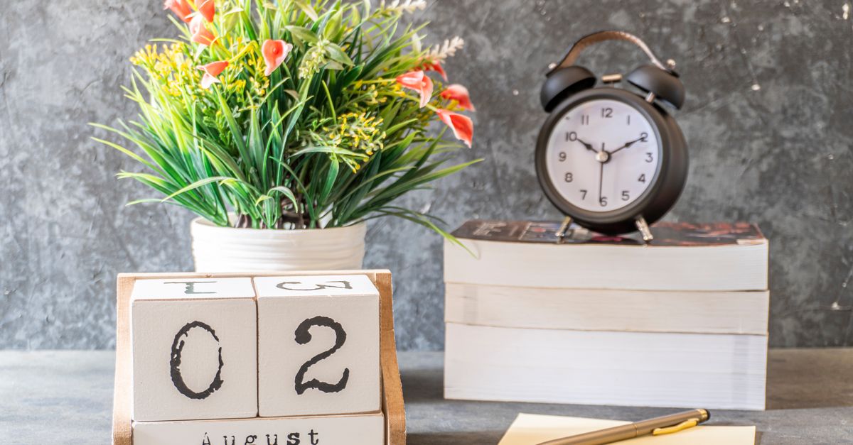 A calendar block and an alarm clock on a desk, for planning ahead.